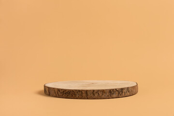 Round wooden saw cut cylinder shape for product presentation on a beige background. Round geometric...
