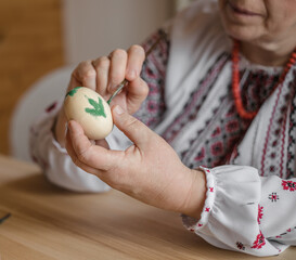 Excited retired old man painted easter egg. DIY craft easter eggs