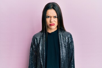 Naklejka premium Young hispanic girl wearing party jacket skeptic and nervous, frowning upset because of problem. negative person.