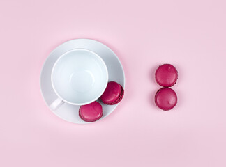 Macarons on a saucer with a cup