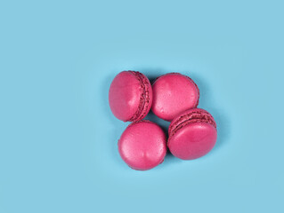 Obraz na płótnie Canvas macaroons with pink icing on a blue background