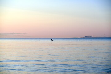 paddle boarding at sunset