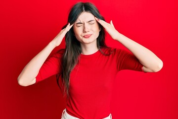 Obraz na płótnie Canvas Young beautiful caucasian girl wearing casual red shirt with hand on head, headache because stress. suffering migraine.