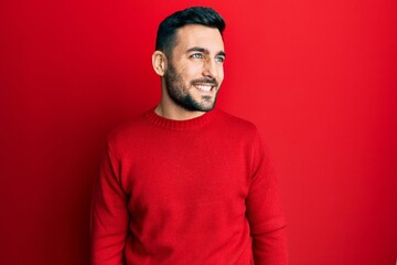 Obraz premium Young hispanic man wearing casual clothes looking to side, relax profile pose with natural face and confident smile.