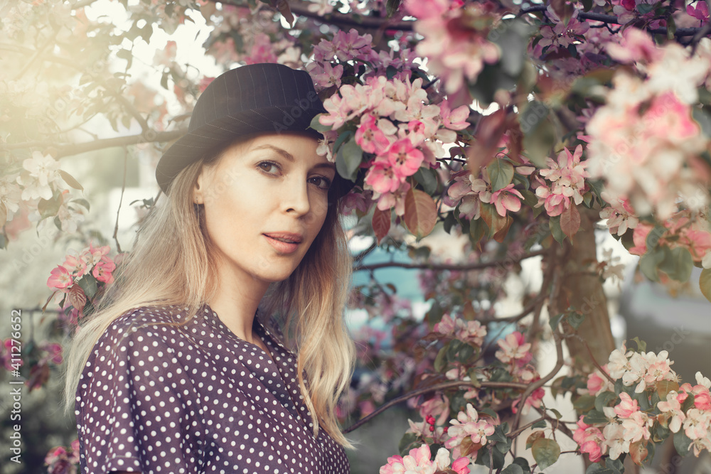 Canvas Prints Portrait of a beautiful woman among spring foliage and flowers