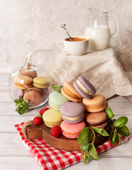 Fototapeta na wymiar Colorful macarons. Small French cakes. Sweet and colorful French macarons cakes on a light background.