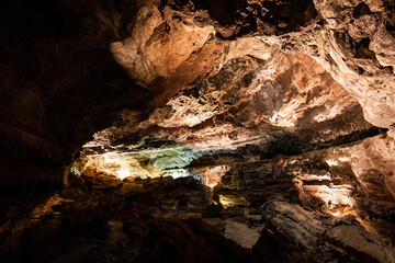 Brown cave lava tube illuminated in Canary Islands. Geological cavern formation, tourist attraction concepts
