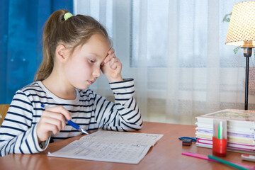 Dreamy little girl sit at desk studying look in distance visualizing or thinking, small child dreamer feel unmotivated distracted from preparing doing homework at home, lost in dreams or imagination