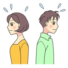 A young couple back to back and blushing shyly