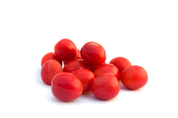 Group of red wild cherry plums in the glass vase isolated on the white background.