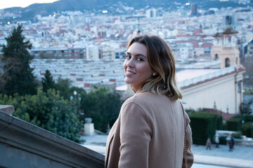 Closed up of a sophisticated woman smiles and enjoys the views of the city of Barcelona