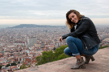 Closed up of a sophisticated woman smiles and enjoys the views of the city of Barcelona