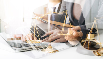 Business and lawyers discussing contract papers with brass scale on desk in office. Law, legal services, advice, justice and law concept picture with film grain effect