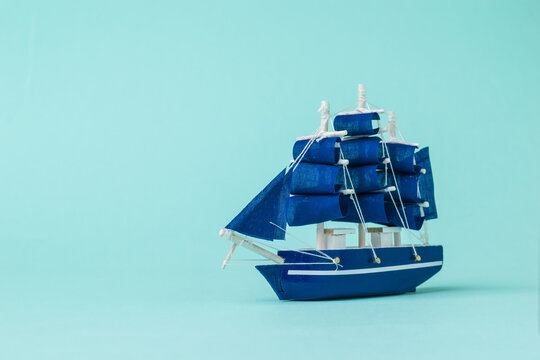 Image of a model sailboat on a light blue background.