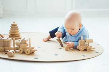 Baby playing with wooden toys. Zero waste, eco friendly concept