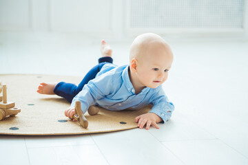 Naklejka premium Baby playing with wooden toys. Zero waste, eco friendly concept