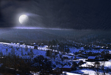 Fototapeta premium Full moon rises from behind a hill, snowy hills and houses