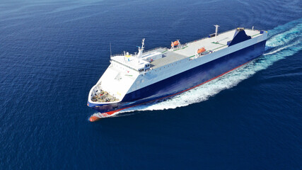 Aerial drone photo of Roll on Roll off vehicle carrier vessel (RO RO) cruising in Aegean deep blue sea, Greece