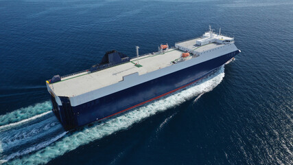 Aerial drone photo of Roll on Roll off vehicle carrier vessel (RO RO) cruising in Aegean deep blue sea, Greece