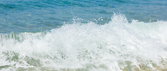 Sea wave and pebble. Summer vacation concept. Sea wave with foam incident on the coastal shingle. Travel concept