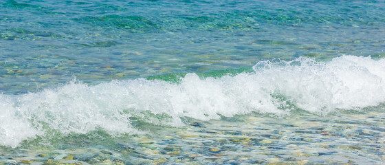 Sea wave and pebble. Summer vacation concept. Sea wave with foam incident on the coastal shingle. Travel concept