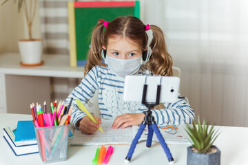 Distance education concept. Covid lockdown. Caucasian girl learns to draw online during...