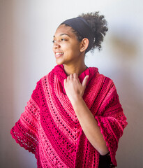 Young girl with red and pink poncho or shawl