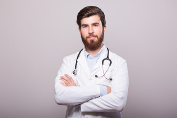 Fototapeta premium Portrait of confident young medical doctor on withe background