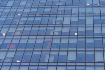 Fototapeta na wymiar Moscow offices building exterior in winter sunny day. Blue sky had been reflected in the glass of windows. Futuristic business concept.