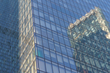 Moscow offices building exterior in winter sunny day. Blue sky had been reflected in the glass of windows. Futuristic business concept.