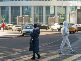 Modern Moscow business district during coronavirus pandemic time. People walking in winter sunny day. Lifestyle concept. Back, rear view.