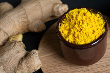  raw ginger and  curcuma seasoning around black background.  healthy and food concept. close up