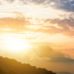 mountain silhouette in dense mist at the dramatic sunset, natural travel background