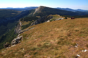 Hikers take in the view from the plateau de Beure on a July afternoon (Vercors, France).