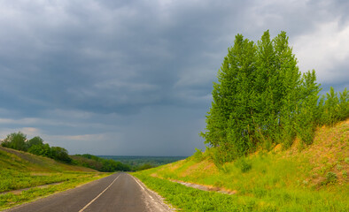 asphalt road among green hills