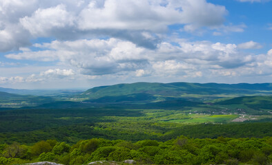green mountain valley under blue cloudy sky