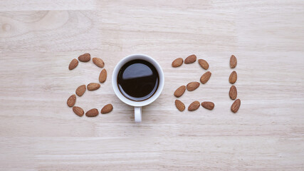 2021 made from almond withcoffee on wooden background, Happy New year