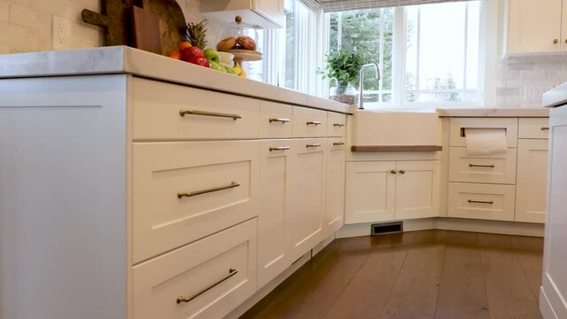 Kitchen Cabinets And Floor. Panning video of beautiful white kitchen.