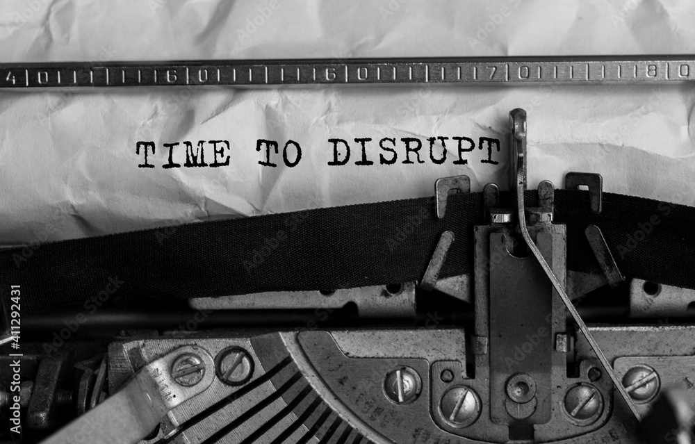 Poster text time to disrupt typed on retro typewriter
