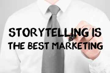 Businessman writing word Storytelling is the best marketing with marker, Business concept
