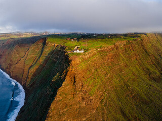 The cliff lighthouse Ponta do Pargo on the cliff coast of the Island of Madeira - Wonderful cloudy...