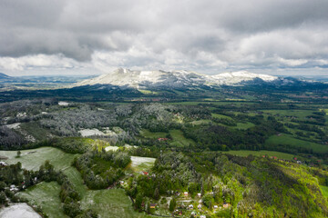 Fototapeta na wymiar Mountains in the Czech Republic in spring with green fields and snow in the mountains 