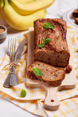 Banana bread with walnuts, hazelnuts and cinnamon. Sweet homemade dessert.