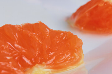 macro photo mandarin slices in a white plate close up several pieces of lie on the table background out of focus