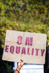 Hand of a protester holding a banner calling for gender equality on March 8, International Women's Day. Feminism, demonstrations, protest, women's rights.