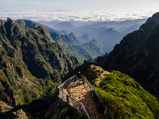 Man enjoys breathtaking view over beautiful mountainous green landscape on Madeira Island