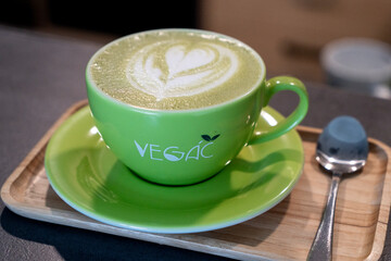 Matcha latte in a green cup with latte art