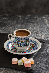 Obraz na płótnie Canvas Turkish Coffee with traditional porcelain cup. Coffee presentation with Turkish delight.