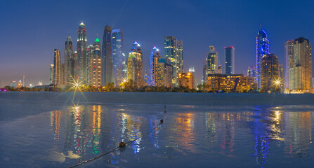 DUBAI, UAE - MARCH 28, 2017: The evening skyline of Marina towers from beach.