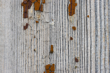 Texture of old weathered rough cracked wood surface with peeling paint. Vintage rustic background.